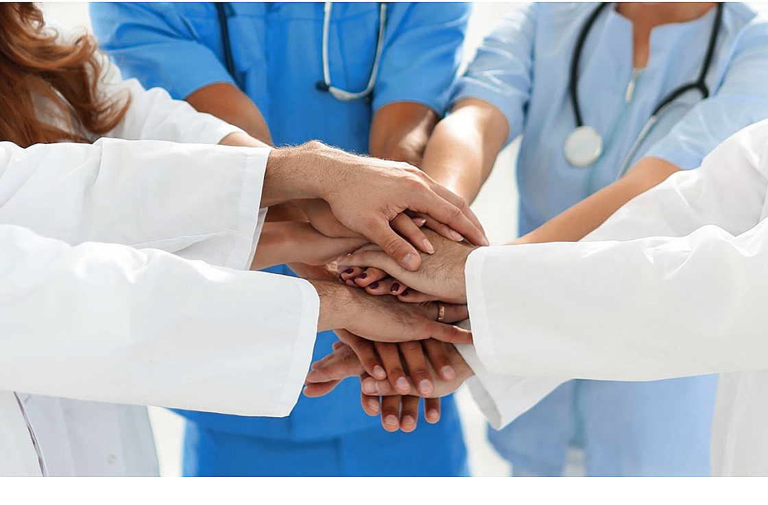 Care team joining hands